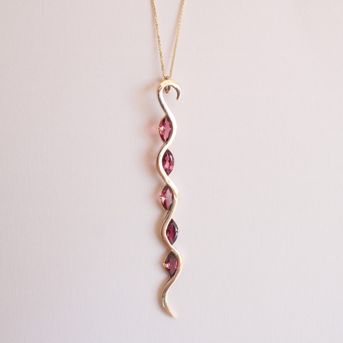 Sleek 18ct rose gold necklace with pink tourmaline gemstones.
